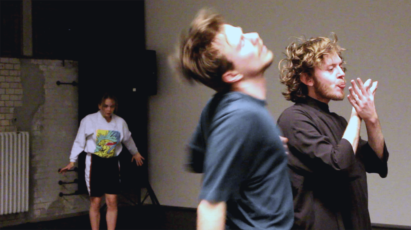 Three people are dancing expressively. 