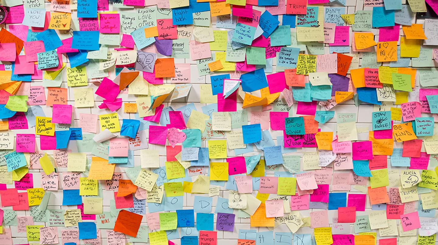 A notice board full of colorful post-it notes