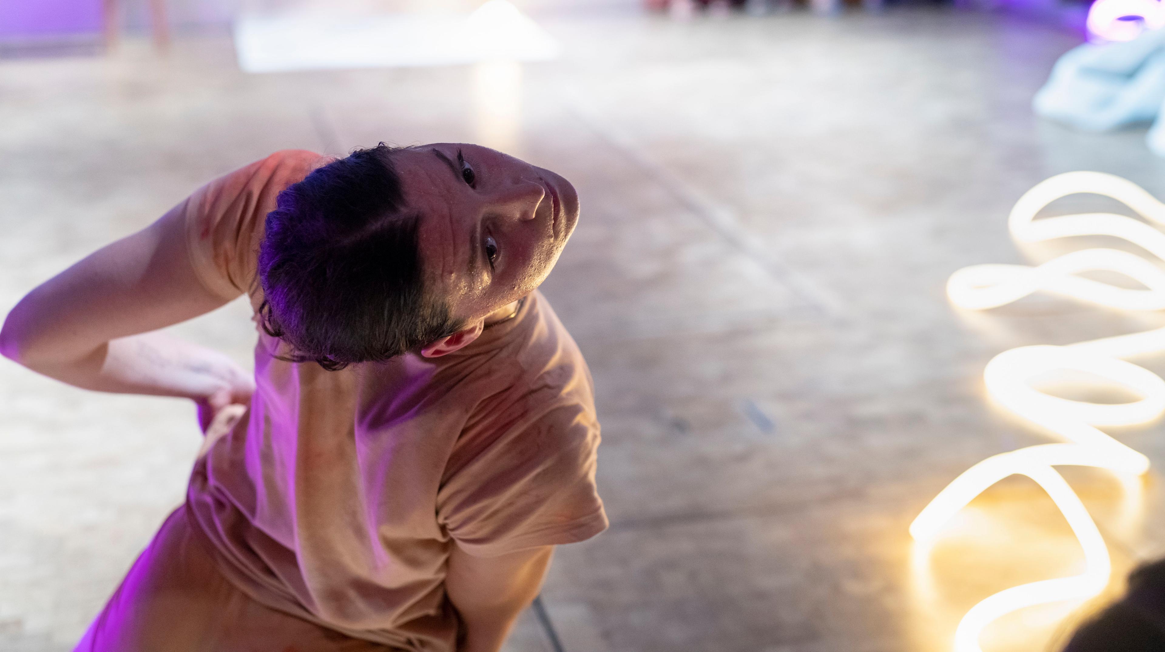 A person makes a dance movement towards the camera 