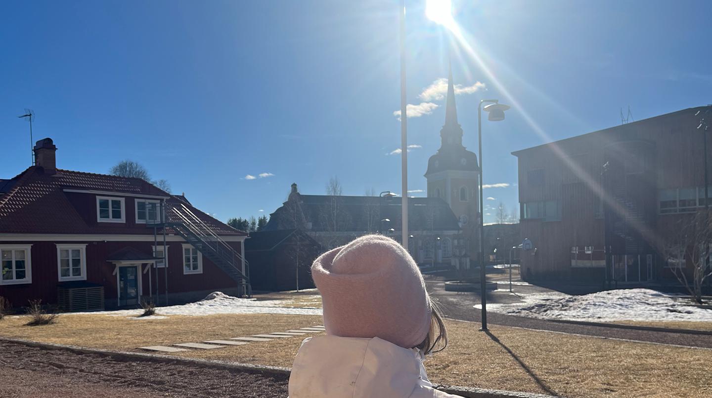 Someone is looking up at a sunny blue sky.