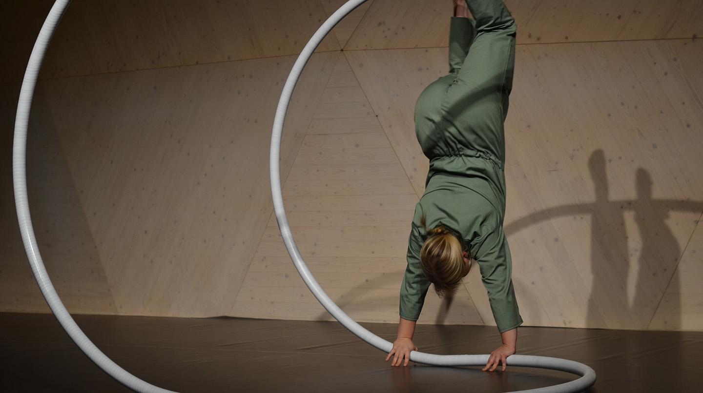 Circus artist doing a handstand on an apparatus